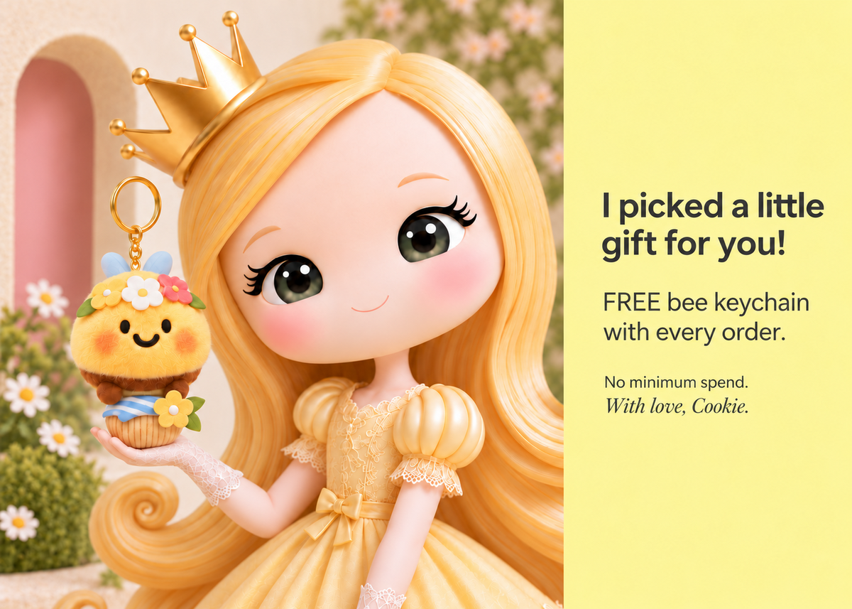 Cookie holding a bee keychain. I picked a little gift for you! FREE bee keychain with every order. No minimum spend. With love, Cookie.