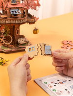 Hands joining wooden wall pieces while building the Rolife Sakura Tree House TGS04 3D puzzle