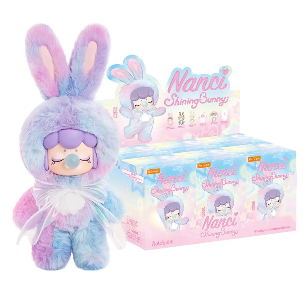 Purple Dreamer bunny plush shown beside the Nanci Shining Bunny display carton.