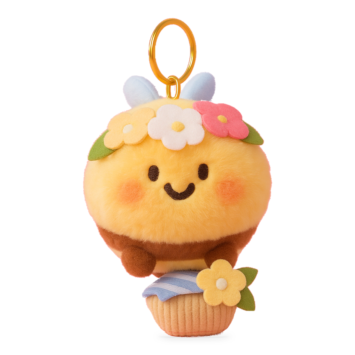 Adored Kids bee plush keychain with a flower crown, blue wings and a cupcake on a pink display stand.