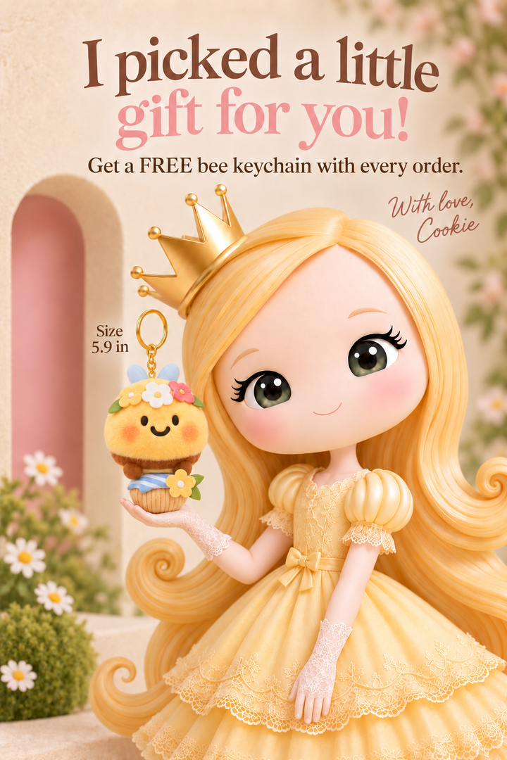 Cookie holding the current gift: a bee plush keychain