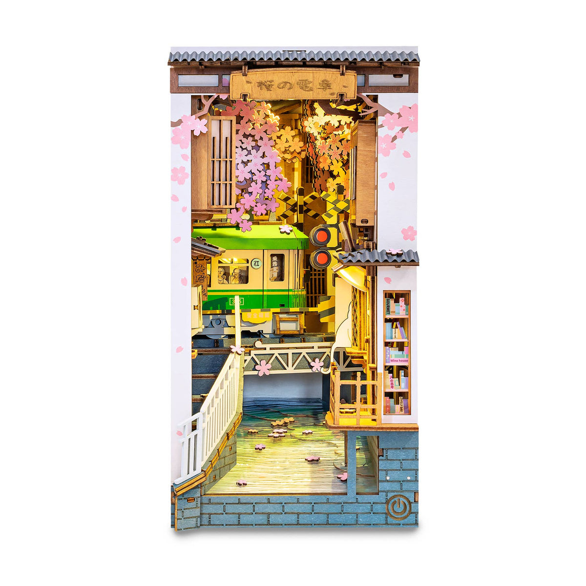 Front view of Rolife Sakura Densya TGB01 illuminated book nook with green train, bridge and cherry blossom-lined canal