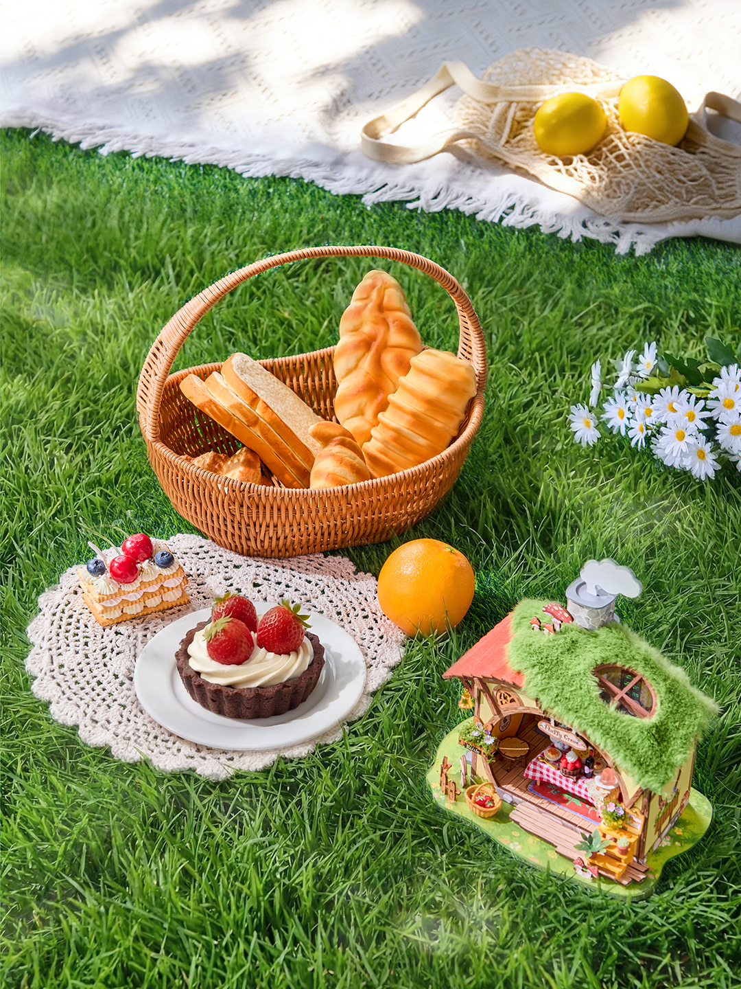 Overhead picnic scene with Rolife Fluffy Grove DG184 miniature house, bread basket, cakes and daisies