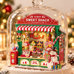Assembled Rolife Christmas Candy Stand DS043 with festive lights, styled under a glass dome used as a display prop.