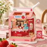 Assembled Rolife Strawberry Milk Box DS034 miniature shop with a pink carton roof, styled beside strawberries.